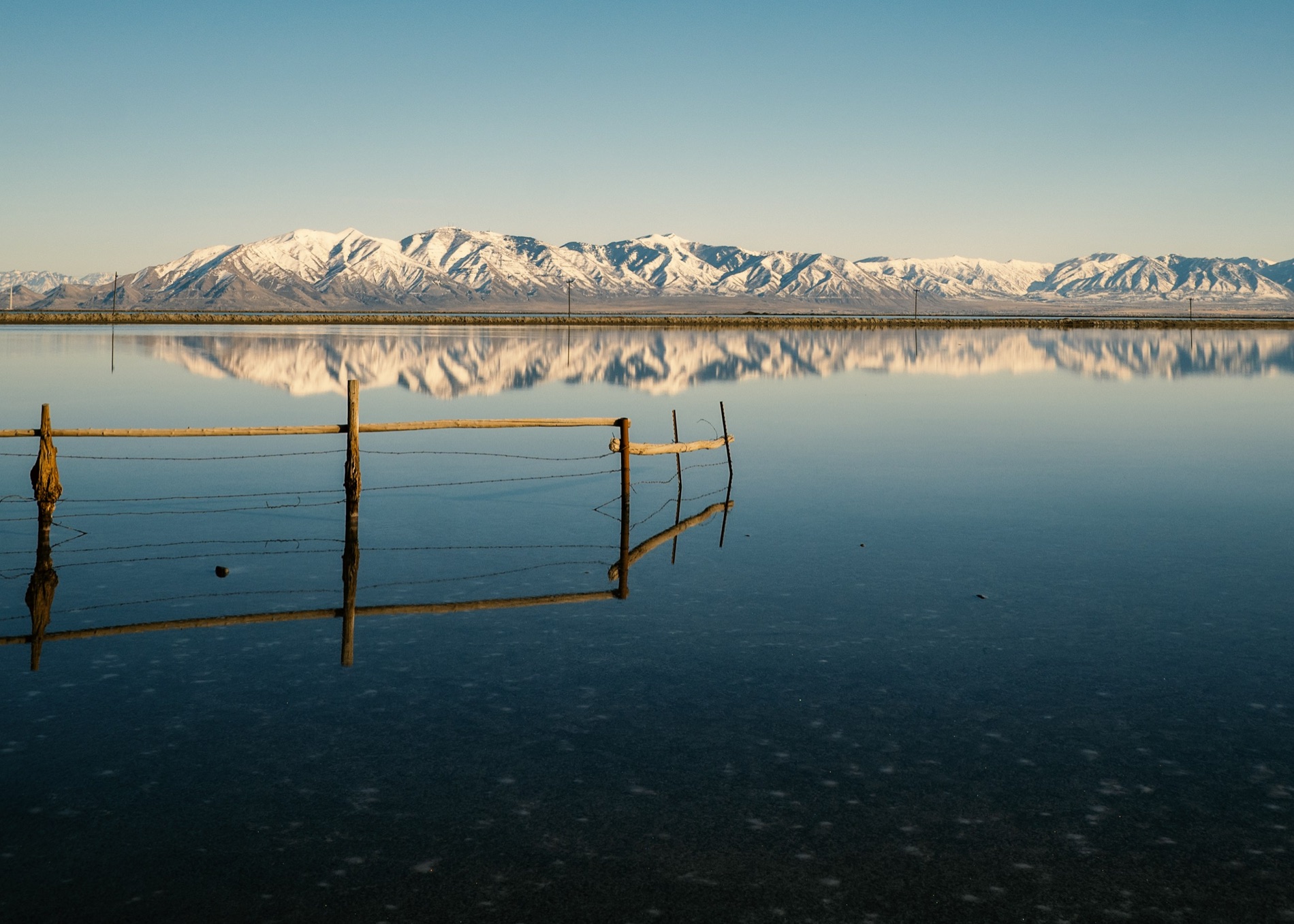 Snow-covered Utah mountains reflected in the still waters of the Great Salt Lake
